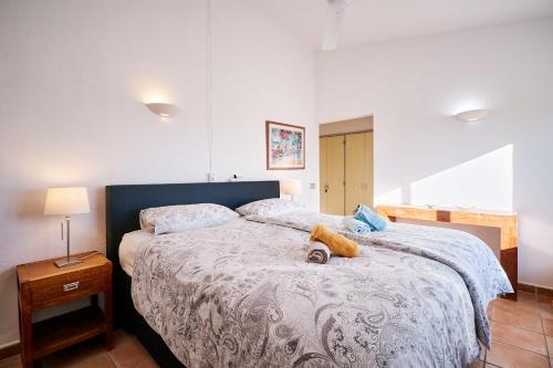 a bedroom with a large bed with a blue headboard at Apartment Kornelius in Carvoeiro