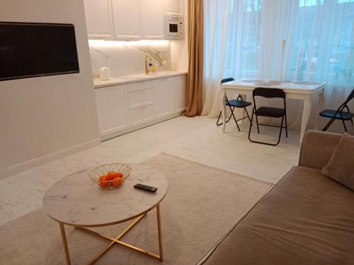 a living room with a couch and a table at Apartament Glamour Chełm in Chełm
