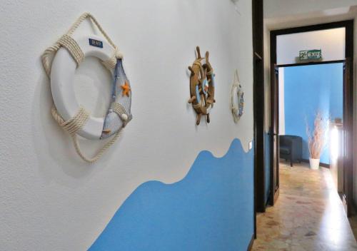 a hallway with a wall with fish decorations on it at La Feluca Rooms & Breakfast in Messina