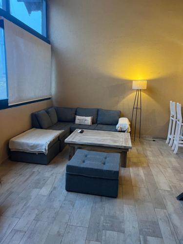 a living room with a couch and a coffee table at Casas De Montaña Las Leñas Los Molles in Los Molles