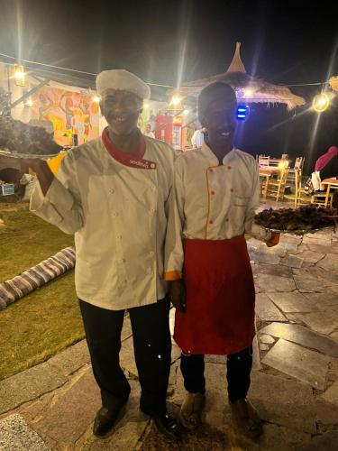 two people standing next to each other in front at Fenti Nubian Resort in Aswan