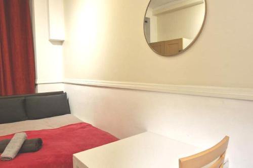 a small room with a mirror on the wall at Private London Kensington studio 2 mins from tube in London