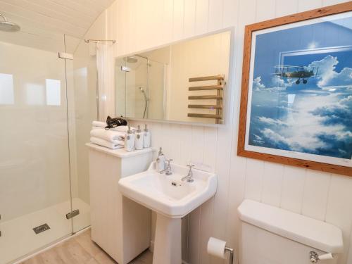 a bathroom with a sink and a toilet and a mirror at Amy Johnson in York