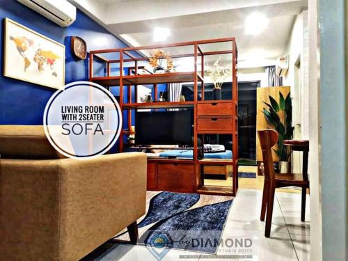 a living room with a sofa and a tv at Timurbay Seafront Residence byDiamond Studio Suites 1 plus 1 in Kuantan