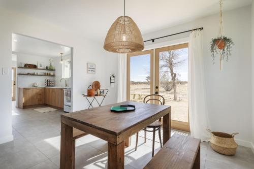 a kitchen and dining room with a wooden table and chairs at Mojave Mesa - Desert Views & Desert Style home in Yucca Valley