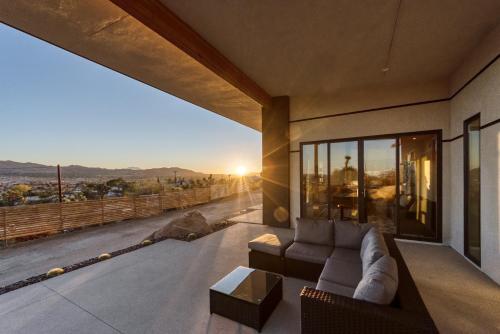 a living room with a couch and a view at Desert Ridge - Hot Tub, Fire Pit, BBQ, Out Door Shower & Incredi home in Yucca Valley