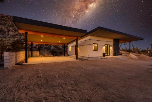 a building at night with the milky way in the sky at Desert Ridge - Hot Tub, Fire Pit, BBQ, Out Door Shower & Incredi home in Yucca Valley