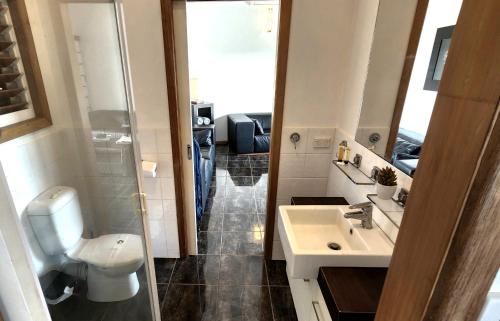 a small bathroom with a toilet and a sink at Bella Vista on Nara Stay 4n each guest get free Day trip Kens Klassic Kombi in Airlie Beach