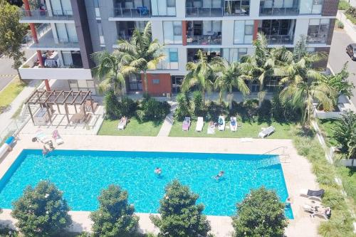 an overhead view of a swimming pool in front of a building at Pool View of Marquarie Park Paradise in Sydney