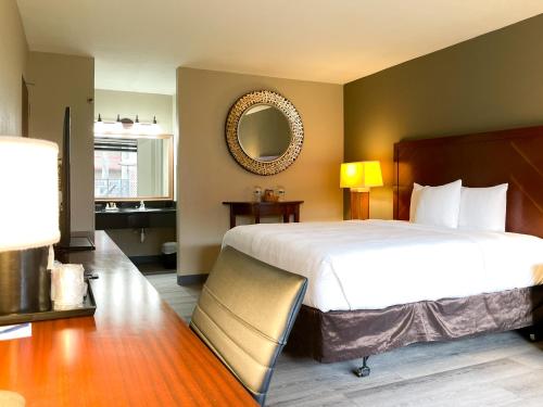 Habitación de hotel con cama grande y espejo en GreenTree Hotel & Extended Stay I-10 FWY Houston, Channelview, Baytown, en Channelview