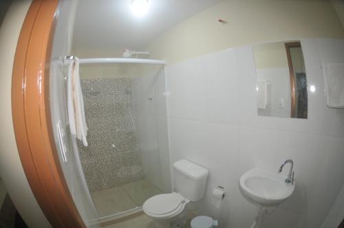 a bathroom with a shower and a toilet and a sink at Hotel hawaii in Campos dos Goytacazes
