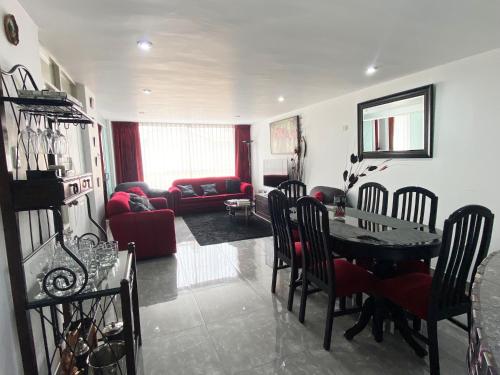 a living room with a table and chairs and a couch at Ayli Apart Hotel in Arequipa