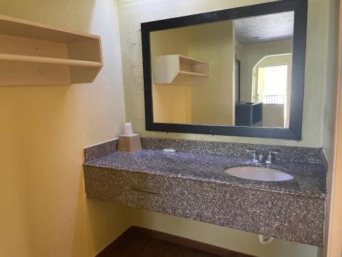 a bathroom with a sink and a mirror at Mustang inn in Jackson