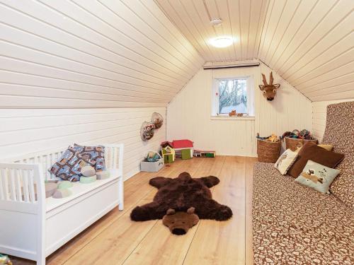 a large teddy bear laying on the floor of a room at 6 person holiday home in Løkken-By Traum in Løkken