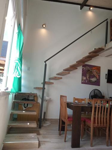 a dining room with a table and a staircase at Vacaciones2023 in Mar del Plata