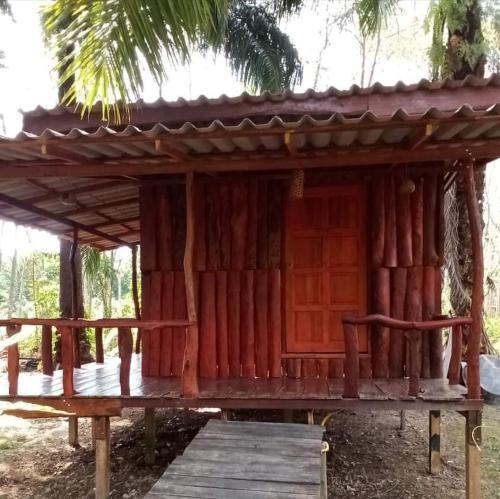 a small wooden building with a wooden porch at Koom Kachanaan in Ban Nong Thale