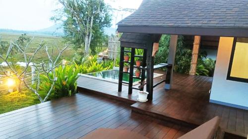 a deck with a hot tub on a house at Rongna Villas in Ko Yao Noi