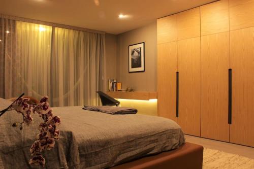 a bedroom with a large bed and a large cabinet at Design Penthouse private panoramic terrace in La Concepción