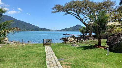 a walkway next to a body of water at Paraíso da Enseada de Brito in Palhoça