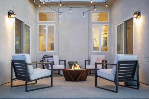 a patio with chairs and a fire pit at Harvest Moon Hideaway - BBQ, Hammocks & Dark Skies home in Joshua Tree