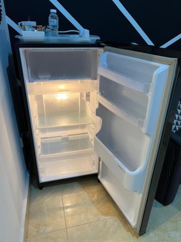 an empty refrigerator with its door open in a room at HIPSTER STUDIO at Kuala Berang for 2Pax -Free Netflix & Wifi in Kuala Berang