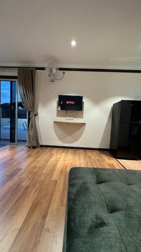 a living room with a flat screen tv on a wall at Adina Pool Villa ~ Cenang Langkawi (3B4R) in Pantai Cenang