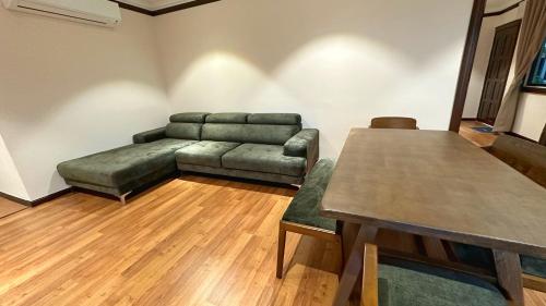a living room with a couch and a table at Adina Pool Villa ~ Cenang Langkawi (3B4R) in Pantai Cenang