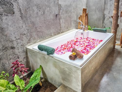 a bath tub filled with sprinkles in a bathroom at Anda Amed Villas & Spa in Amed
