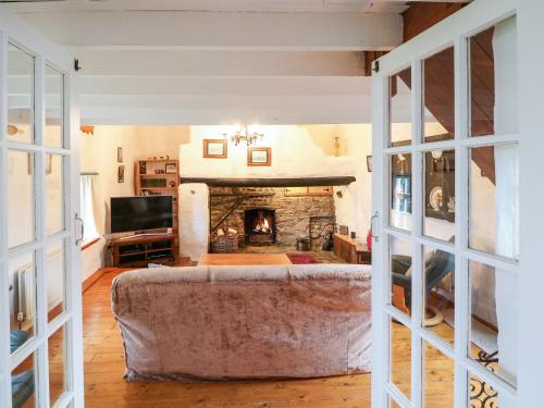 a living room with a couch and a fireplace at Ballintlea in Dungarvan