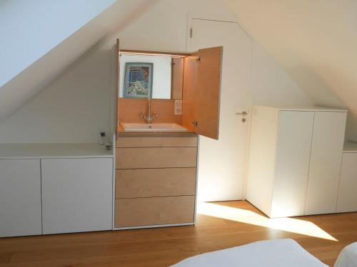 - une salle de bains avec lavabo située sous les escaliers dans l'établissement Charmante grange rénovée avec jardin à 800m de la plage, 6 couchages, moderne et confortable - FR-1-418-208, à Locmaria