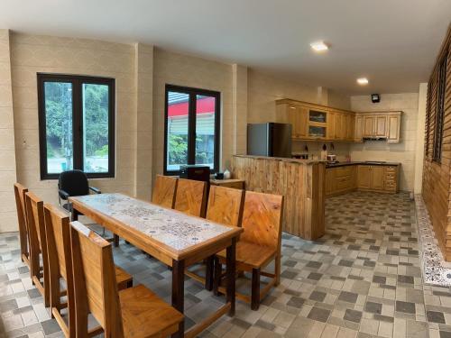 a kitchen and dining room with a table and chairs at Golden Jungle House in Ha Giang