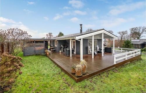a house with a wooden deck in the yard at Pet Friendly Home In Otterup With Wifi in Otterup