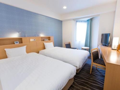 Postel nebo postele na pokoji v ubytování Shibuya Tobu Hotel