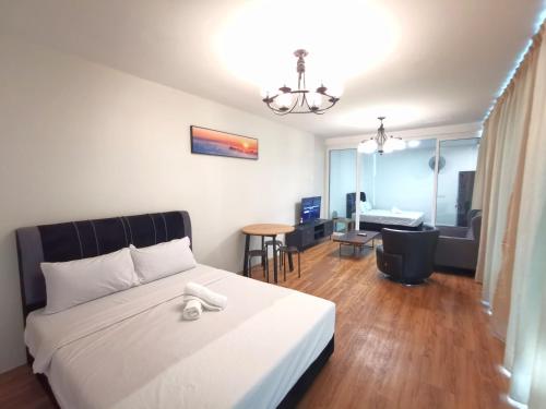 a bedroom with a bed and a living room at ₘₐcₒ ₕₒₘₑ【Private Room】@Sentosa 【Southkey】【Mid Valley】 in Johor Bahru
