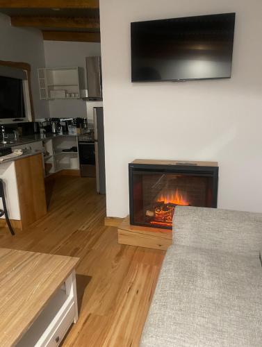 a living room with a fireplace in the wall at Acacia Hills Retreat in Acacia Hills