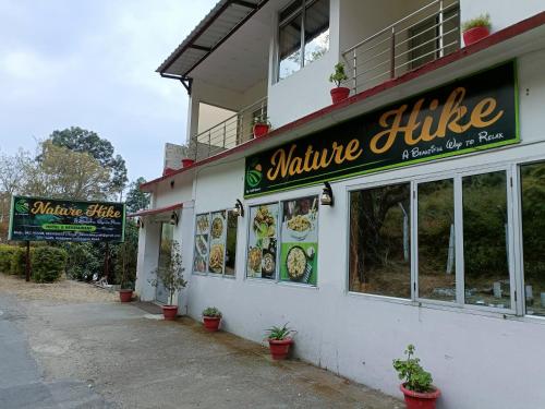 a white building with a sign for a restaurant at Nature Hike in Lansdowne