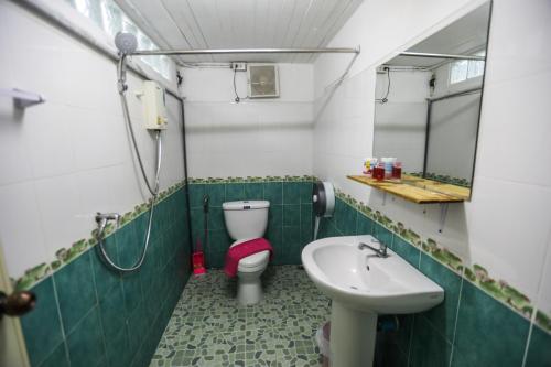 a bathroom with a toilet and a sink at Arena Boutique Hotel Female only in Thongsala