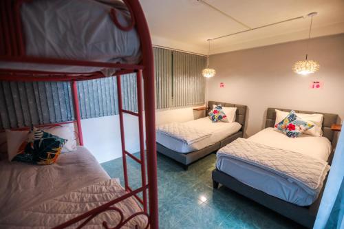 a room with two bunk beds and a couple at Arena Boutique Hotel Female only in Thongsala