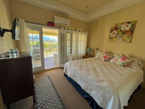 a bedroom with a bed and a balcony at Mi Casa en el Valle de Guadalupe in Valle de Guadalupe