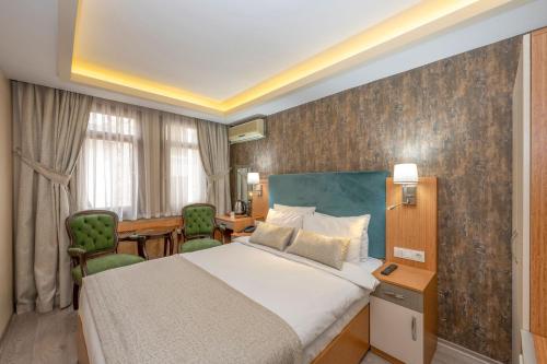 a hotel room with a bed and a desk at Hotel Devman in Istanbul