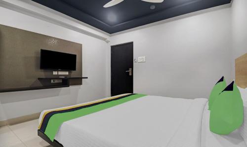 a bedroom with a bed and a tv on the wall at Destino by Halcyon Hotels in Hyderabad