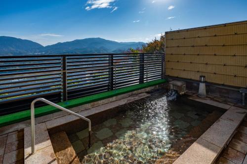 a small pool of water next to a building at Kamenoi Hotel Tondabayashi All-Inclusive Resort in Tondabayashi