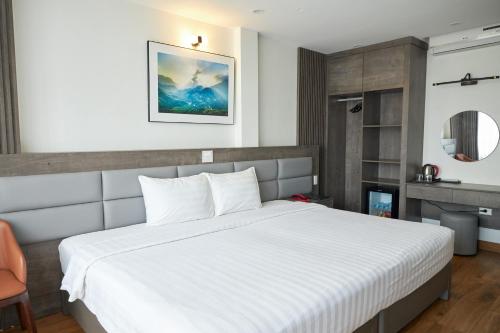 a bedroom with a large white bed in a room at Van Nam Hotel in Ha Long