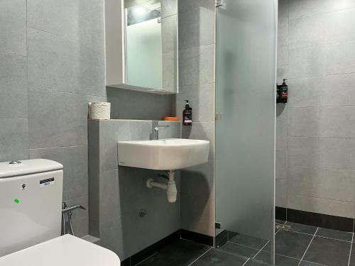 a bathroom with a white toilet and a sink at JESSELTON QUAY SEAVIEW Can Request LateCheckout 2pm in Kota Kinabalu