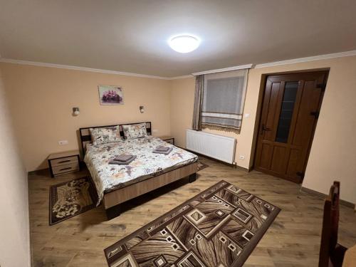 a large bedroom with a bed and a window at Villa Magda in Berehove
