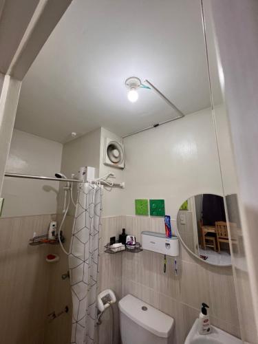 a bathroom with a toilet and a mirror at Dream Condo in Santa Rosa in Santa Rosa
