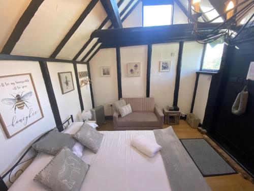 a large bedroom with a bed and a couch at Windsor/Ascot/Bracknell beautiful barn in Bracknell