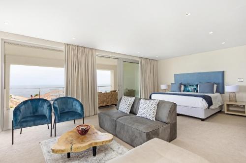 a living room with a couch and a bed at Cape Blue in Cape Town