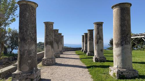 a row of columns on top of a grass field at Relais Villa Giusso in Vico Equense