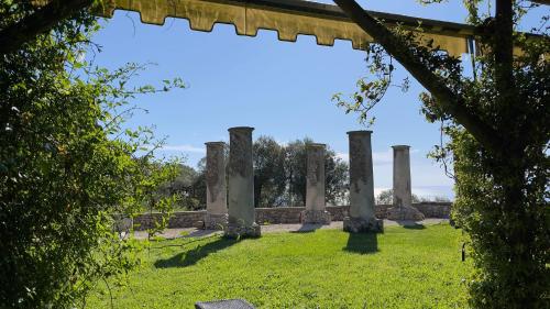 a view of the ruins of a building with columns at Relais Villa Giusso in Vico Equense